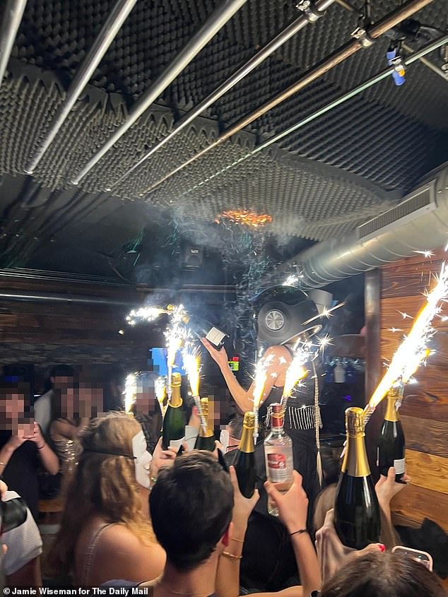 Pictured: The moment sparklers on Champagne bottles started the deadly fire on New Year's Day