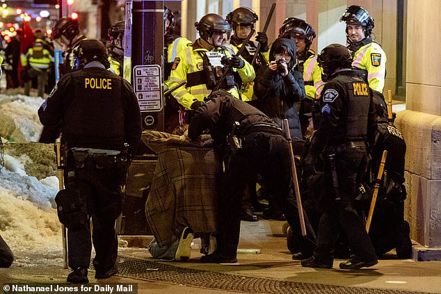 Police tackle one protester to the ground in Minneapolis on Friday