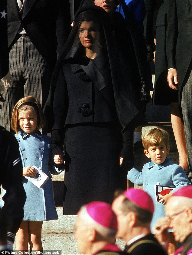 Caroline at the age of five leaving her father's state funeral with her mother, Jackie, holding her and her three-year-old brother John's hands