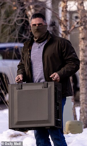An agent wearing a half-face mask, carried out the Ross family's computer tower