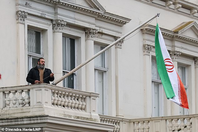 But the protestor's flag was later taken down and replaced with the old flag by an embassy official this evening