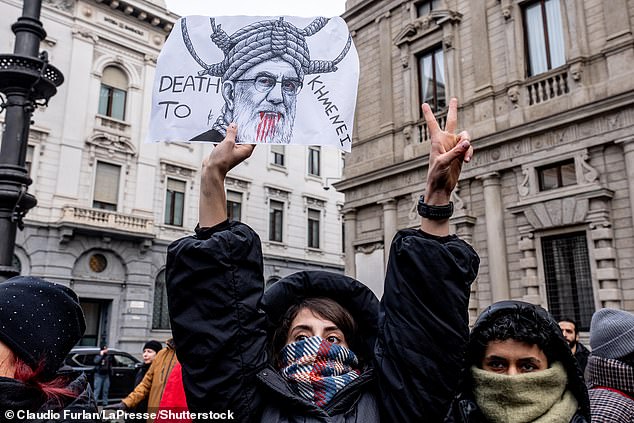 A woman holds a sign that reads 'death to Khemenei' during a protest in Milan, Italy