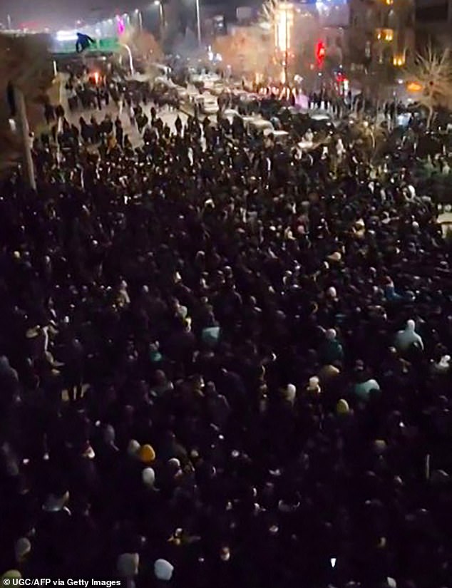Thousands of people took to the streets in Tehran as well as cities and towns across all of Iran's 31 provinces (Pictured: Protesters in Mashhad, northeastern Iran)