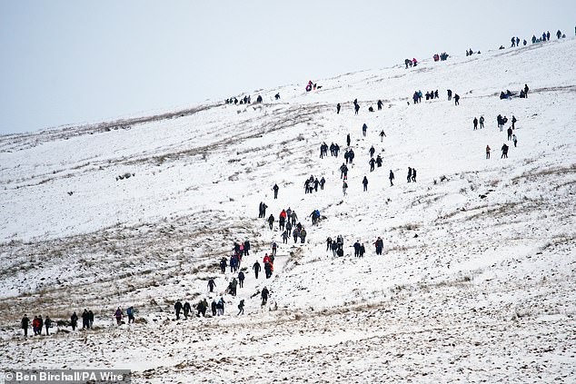A horde of people walk up Pen y Fan in the Bannau Brycheiniog National Park on January 10