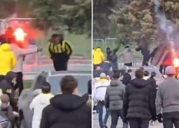 Fenerbahce and Galatasaray fans launch flares at each other as they clash before fierce derby