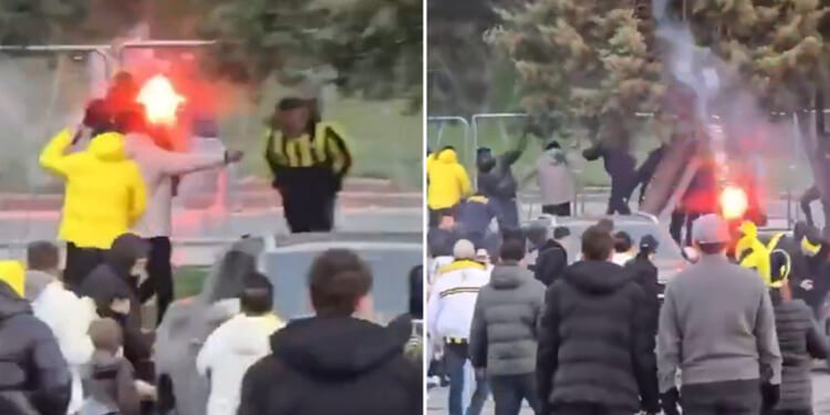 Fenerbahce and Galatasaray fans launch flares at each other as they clash before fierce derby
