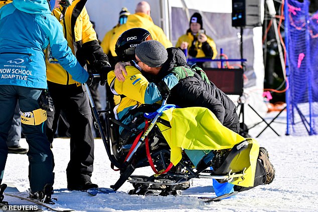 Prince Harry hugs a sit ski athlete at the finals of the alpine skiing novice competition at Whistler Blackcomb