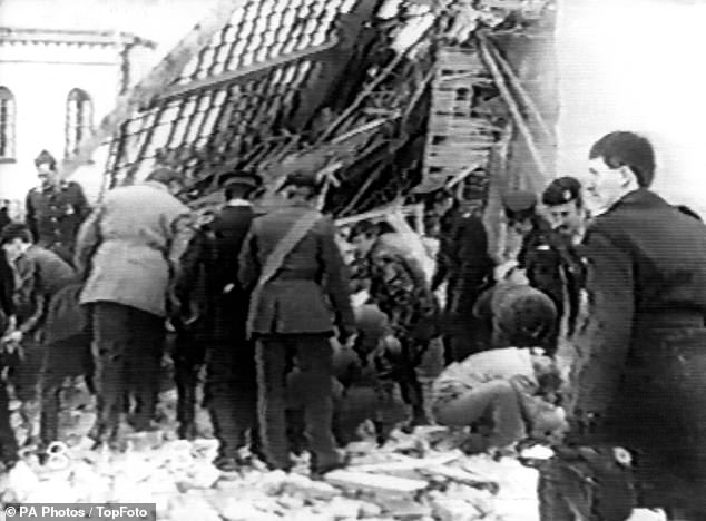 Rescuers clawed at the rubble to free the trapped people underneath