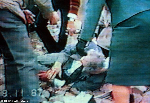 People try to help one of the victims of the attack which took place on Remembrance Sunday