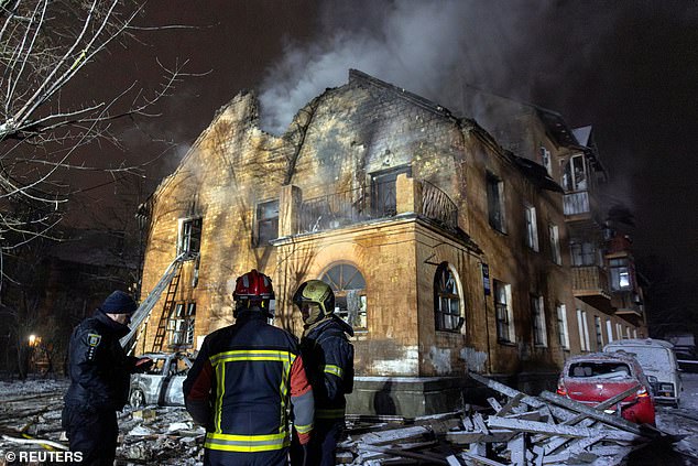 On Thursday night Russia launched a huge wave of drones and missiles against Ukraine, striking civilian targets and energy infrastructure. Pictured: Firefighters stand in front of a  building in Kyiv that was hit during a night of Russian drone and missile attacks
