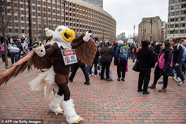 A person dressed as a bald eagle walks around as demonstrators rally outside the JFK Federal building to protest the killing of Renee Nicole Good by an ICE agent in Boston, Massachusetts