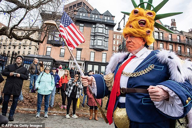 A person dressed up as "king Trump" dances as demonstrators gathered to protest