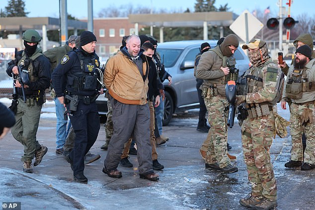 A protester is arrested by federal agents outside the Bishop Henry Whipple Federal Building in Minneapolis
