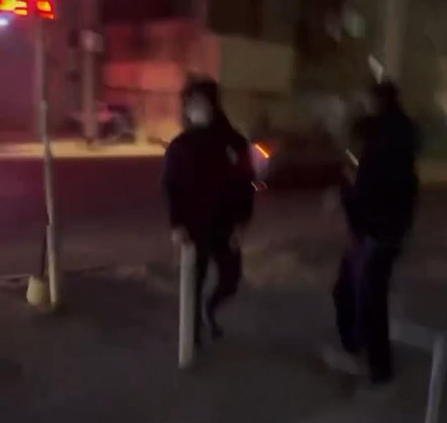 Another leaked clip shows an Iranian man fleeing the scene of a protest after armed security forces descended upon it. 'Listen to the sound,' the man says as loud bangs can be heard, 'they're massacring people'