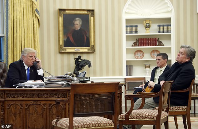 Bannon has told allies he wants to shape the Republican agenda by uniting GOP lawmakers on key issues, per Axios (Pictured: Trump speaks on the phone in January 2017 while then-chief strategist Bannon, shown right, sits alongside then-National Security Adviser Michael Flynn)