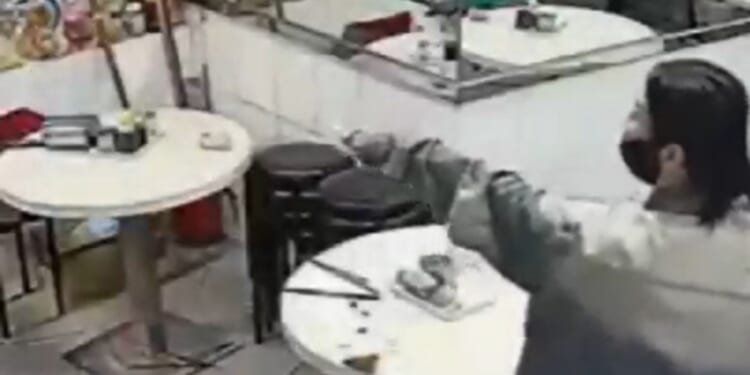 Moment woman brandishes 30cm kitchen knife after her payment failed