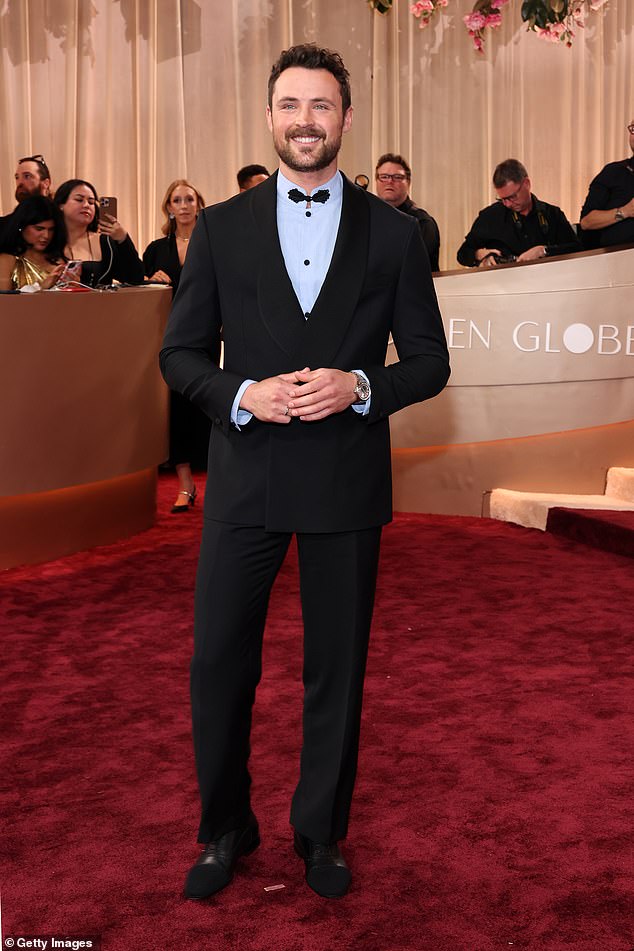 Zac Efron's brother Dylan Efron cut a dapper figure in a black suit with a light blue shirt underneath