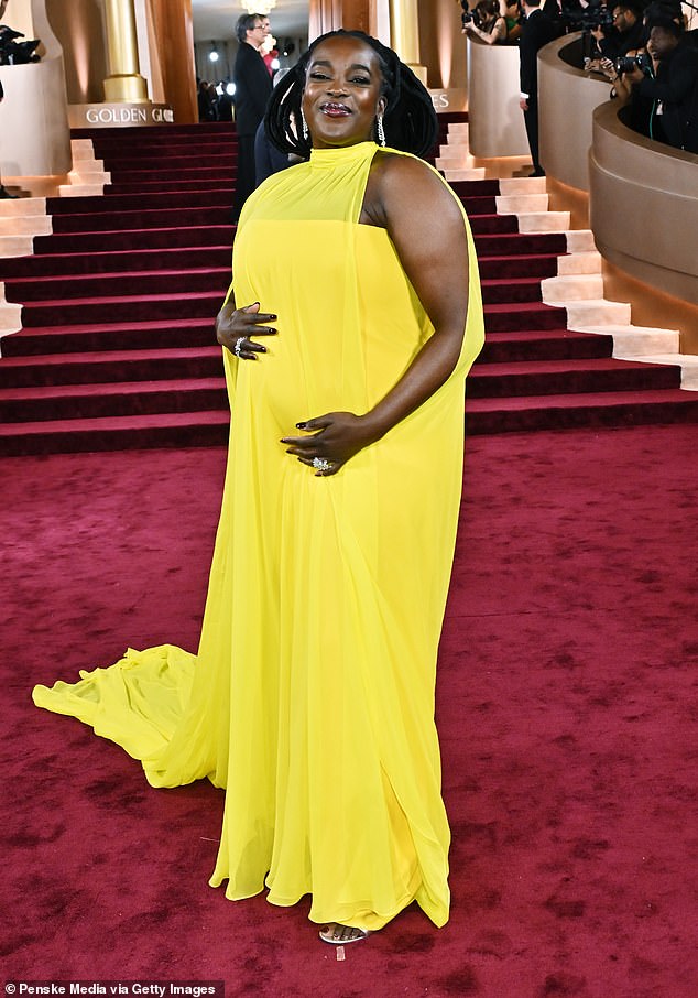 Her stunning ensemble featured a strapless dress topped with a dramatic sheer high-neck drape