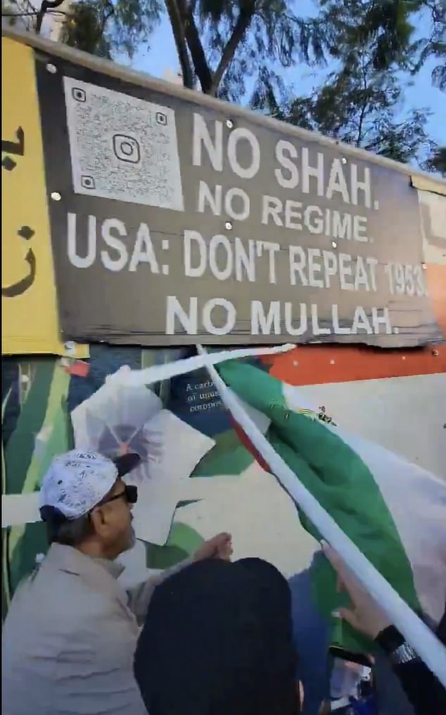 A large banner taped to its side declared: ¿No Shah, No Regime. USA: Don¿t Repeat 1953. No Mullah.¿