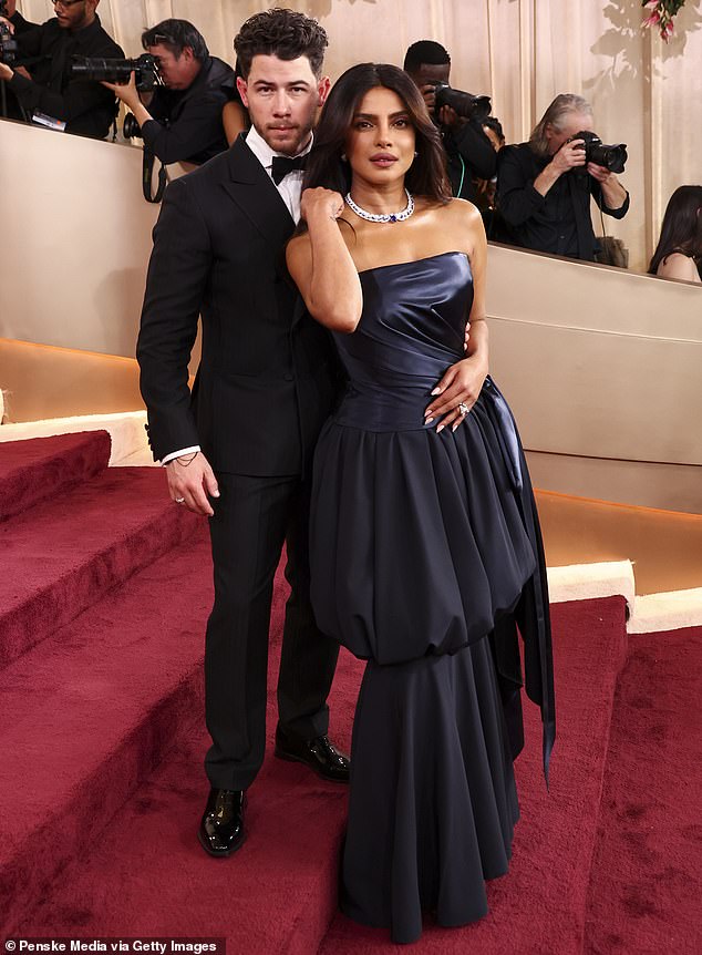 Chopra's off-the-shoulder number offered up a glimpse of cleavage, and was accessorized with a dazzling diamond necklace