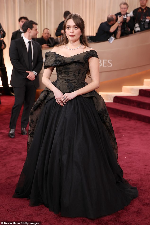 Aimee Lou Wood, 31, commanded attention in an off-the-shoulder black dress featuring a delicate embroidered floral bodice and a flowing full skirt