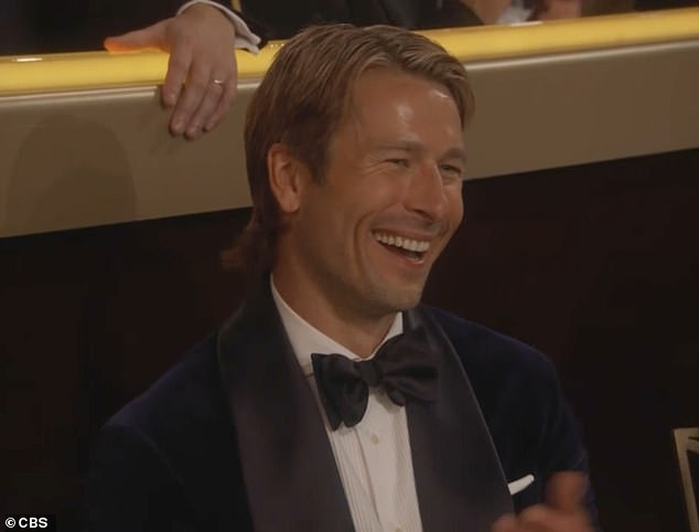 Glen Powell cracked up and clapped in the audience as the camera cut to him