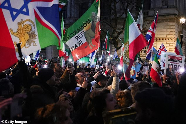 People take part in a rally in solidarity with protesters in Iran today outside 10 Downing Street