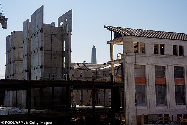 The Washington Monument is visible beyond the 1951 Constitution Avenue Building as a massive renovation continues on the building and the Marriner S. Eccles Federal Reserve Board Building