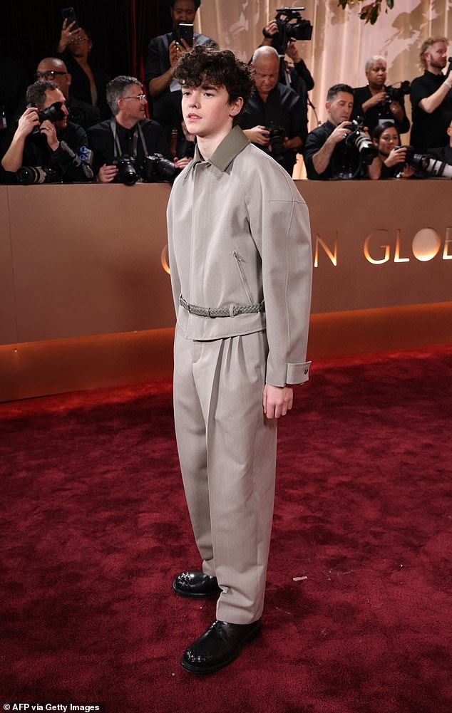Owen rocked a stylish grey tailored co-ord and patent leather shoes