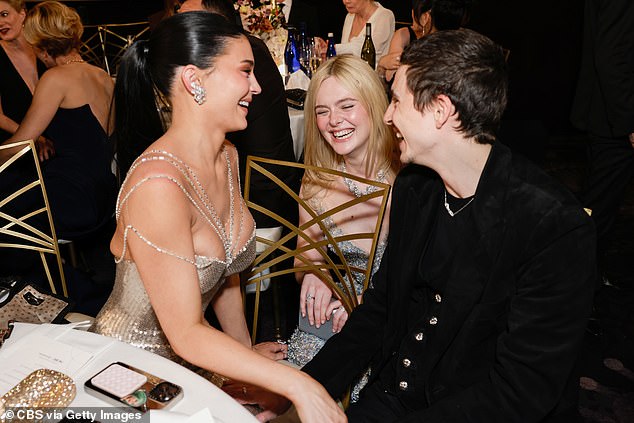 Chalamet and Jenner's table appeared to be a popular destination for other celebrities at the event, with Elle Fanning stopping by to also talk to the couple