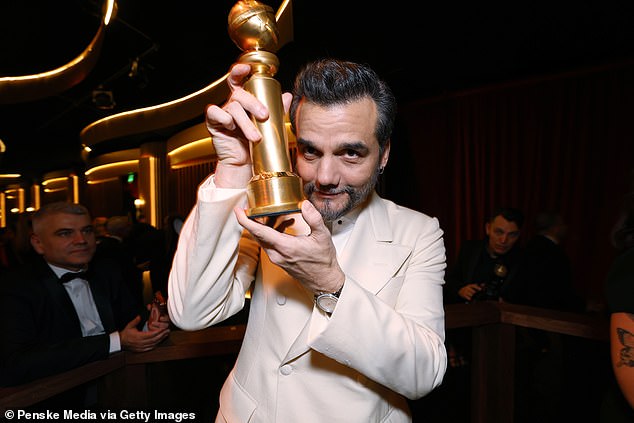 Wagner Moura excitedly help his Golden Globe after winning Best Actor in a Motion Picture, Drama for his role in The Secret Agent