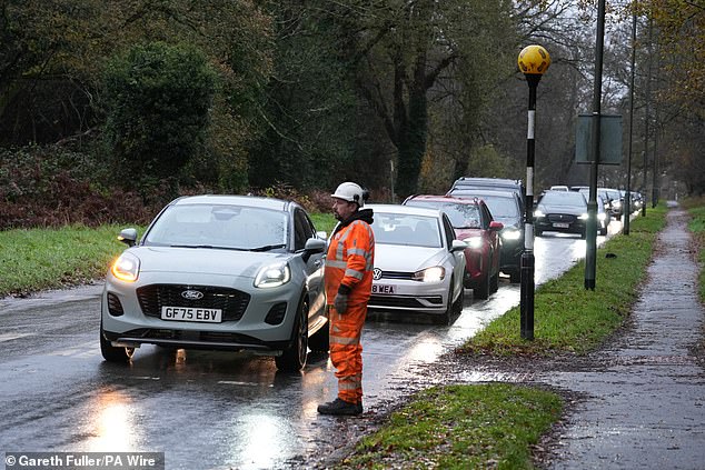 Drivers queue to collect water from the Upper Pantiles car park in Tunbridge Wells, Kent, on December 1