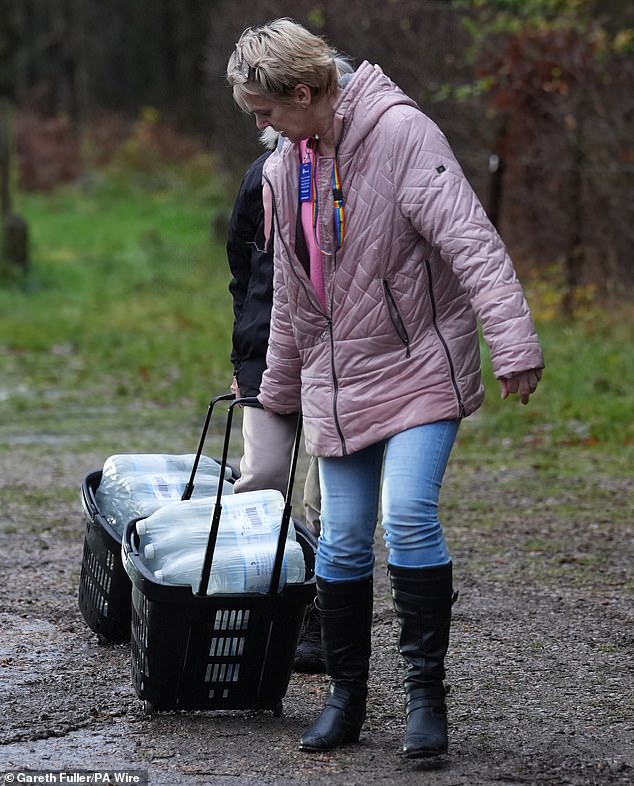 A woman collects bottled water from the Upper Pantiles car park in Tunbridge Wells, Kent, on December 1