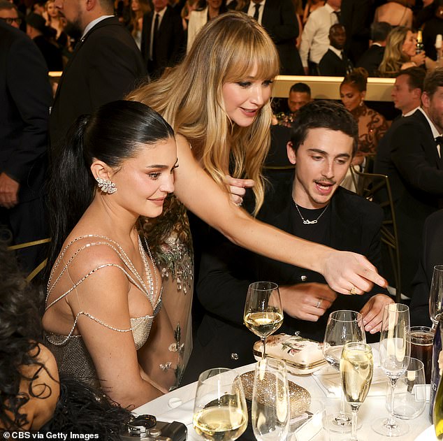 The couple were seated next to each other at one of the many tables - and were suddenly approached by Lawrence who sparked up a conversation with the pair