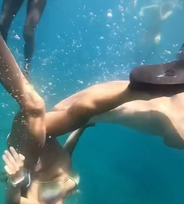 After leaving the water, she was helped by the guide and by fishermen