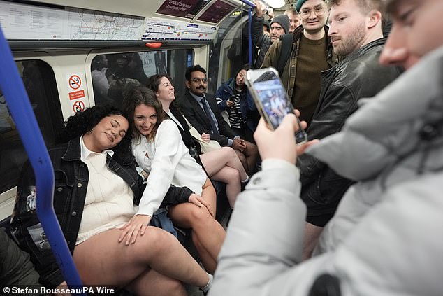 Two women pose for a photo during the annual No Trousers Tube Ride in London yesterday