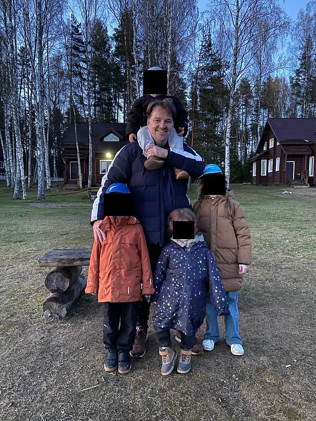Mark pictured with his four children who he lives with in St Petersburg in Russia