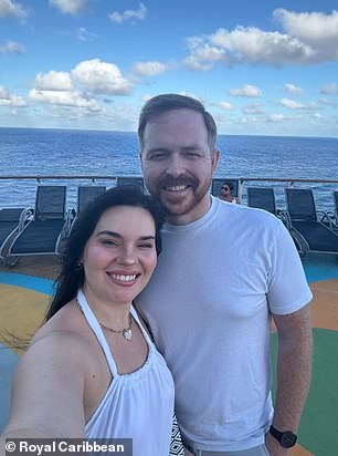 The couple trying to get at least one good picture on the ship during their disaster trip