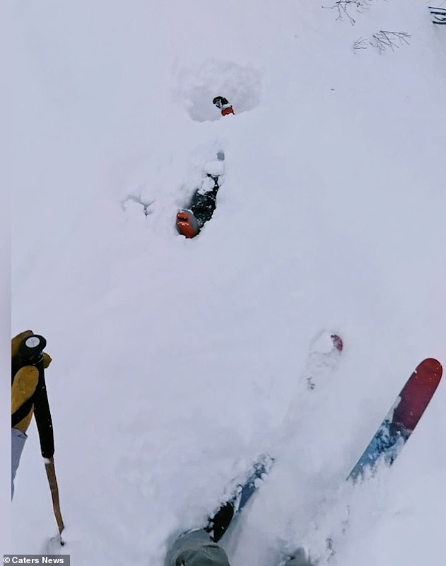 'I'm coming, all good!' Matteo can be heard shouting as he trudges through the deep powder towards the trapped skier, whose arm can be seen waving above the surface