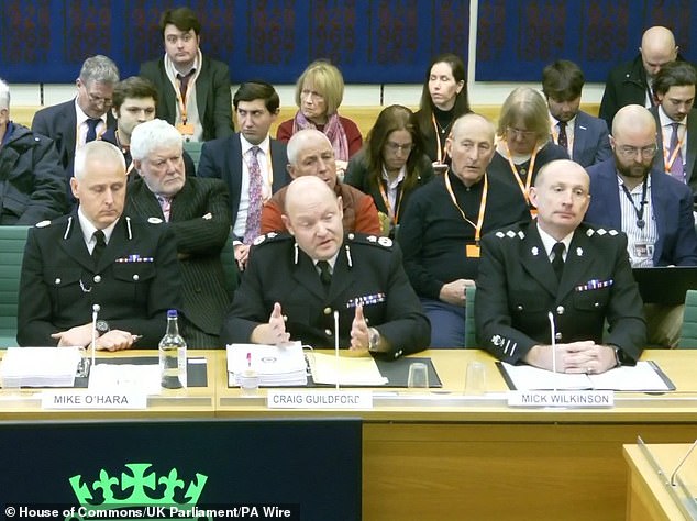 Mr Guildford is flanked by ACC Mike O'Hara (left) and Chief Inspector Mick WIlkinson as he gives evidence to the Home Affairs Committee last week