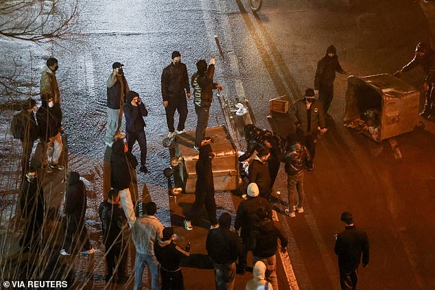 Iranian demonstrators gather in a street during a protest over the collapse of the currency's value, in Tehran, Iran, January 8, 2026