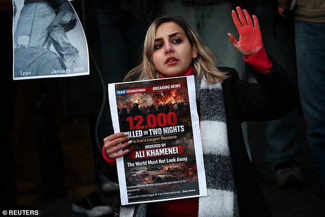 A woman shows a sign during a rally in support of nationwide protests in Iran, in Rome, Italy, January 13, 2026