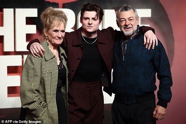 Louis opted for a maroon shirt with matching trousers which he wore with a black T-shirt and silver necklace