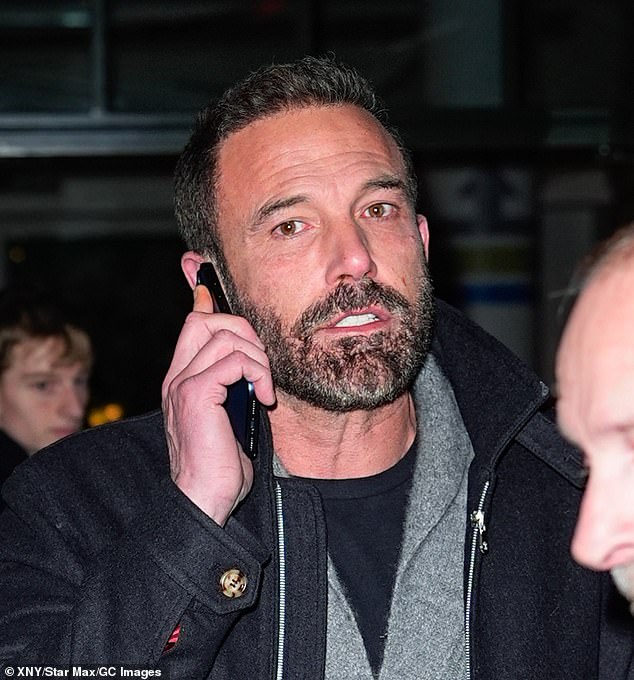 Affleck was glued to hi phone as he made his way back to his car