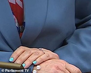 The engagement ring could be seen on her wedding finger at the despatch box