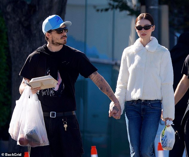 Brooklyn and actress Nicola, 31, put on a show of solidarity as they were pictured out together