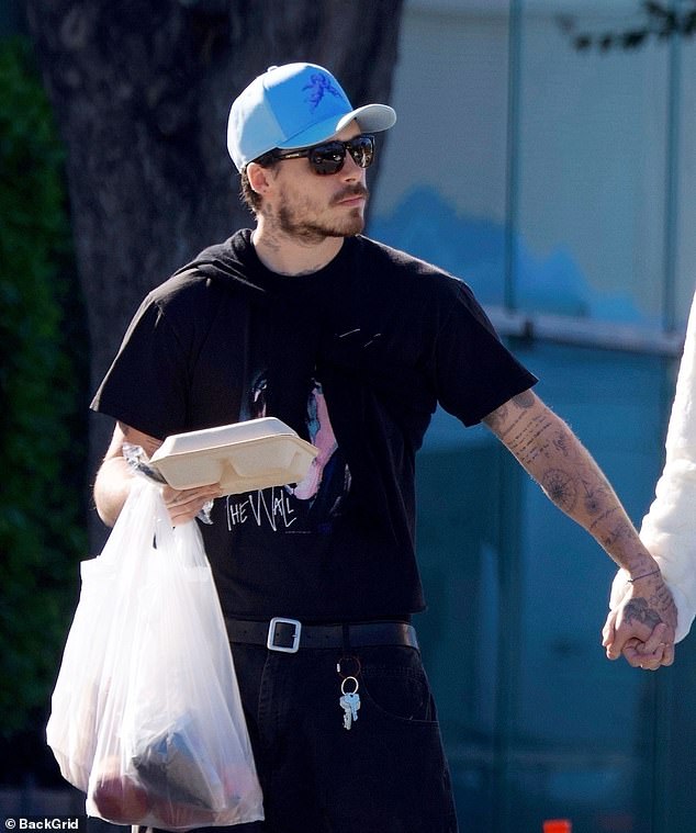 For the low-key outing Brooklyn kept things casual in a black graphic top and denim shorts