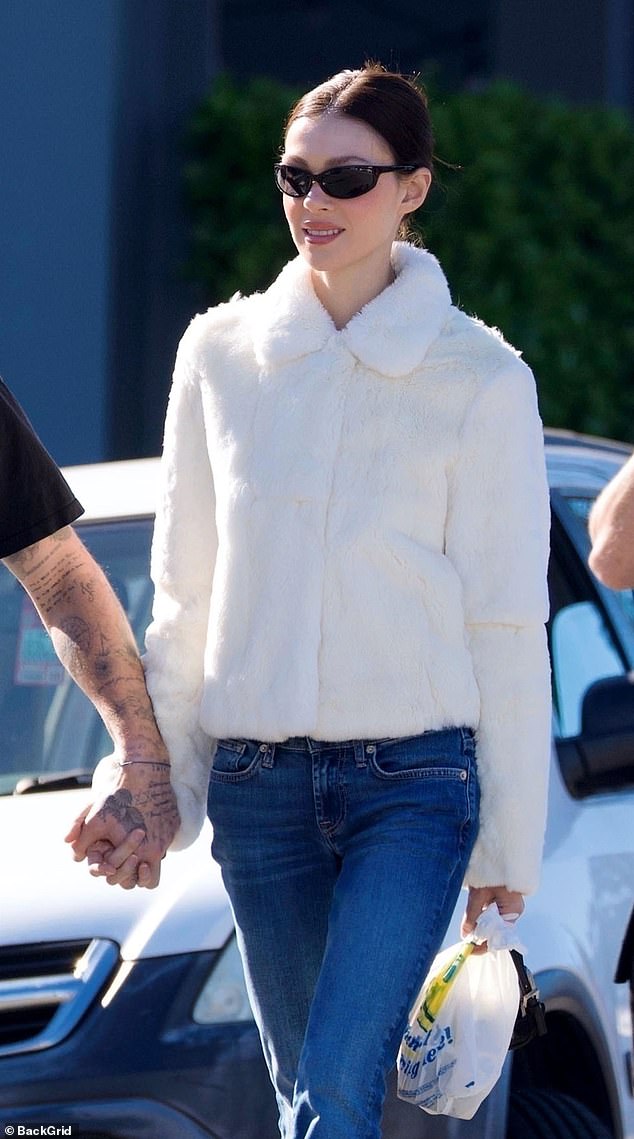 Meanwhile Nicola, 31, looked cosy in a white fur jacket