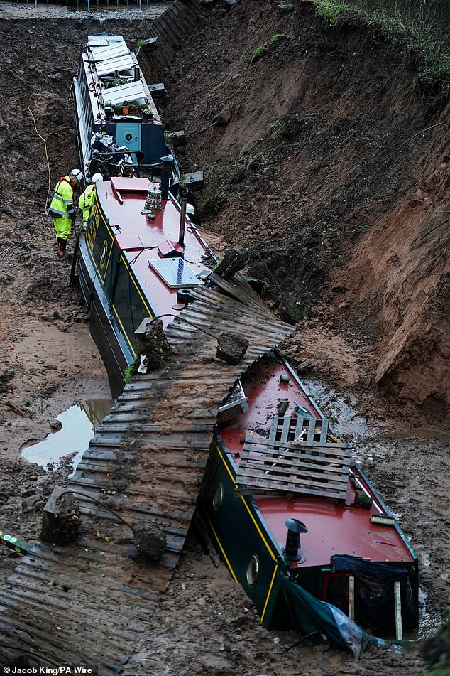 Firefighters were called to rescue occupants of three narrowboats after the section of the canal they were moored in was completely drained of water