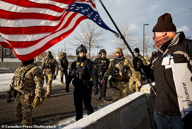 Federal agents gather before a rally for Renee Good, who was fatally shot by an ICE officer earlier in the week, at a federal building in Minneapolis on Saturday